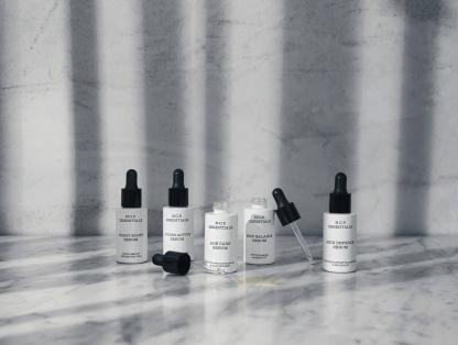 Vegan skin care from N.C.P Essentials. The boost line of Skin care on marbel table. Age Care Serum and Skin Balance Serum is open and showing the pipette.Age Care Serum, Hydro Active Serum, Night Boost Serum, Skin Balance Serum & Skin Defence Serum